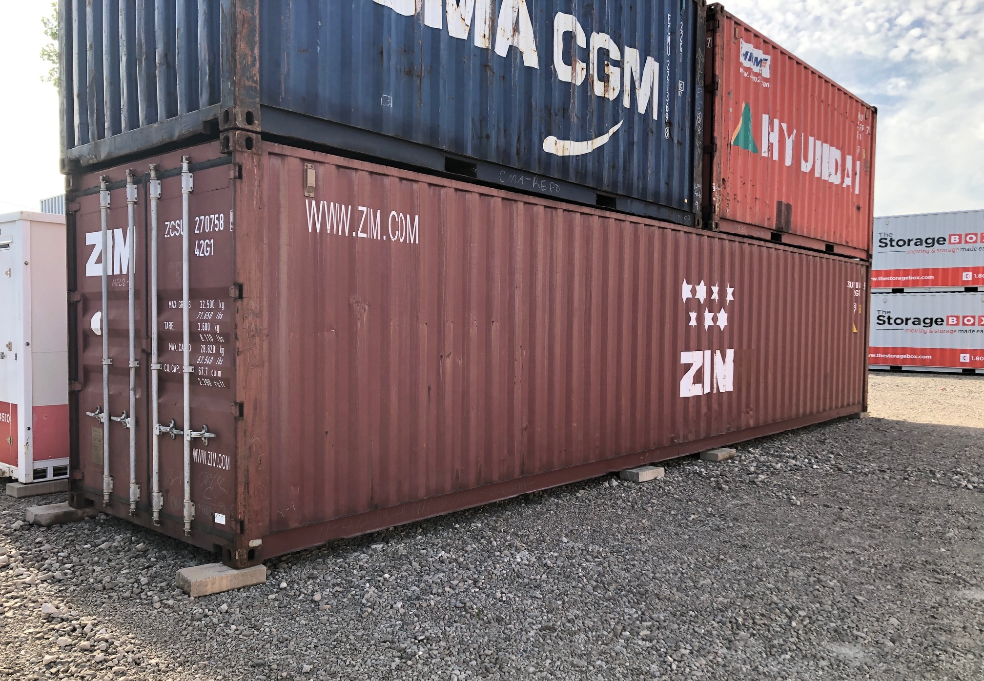 Stacked shipping containers for sale in various grades, including one-trip, cargo worthy, and wind and watertight – The Storage Box